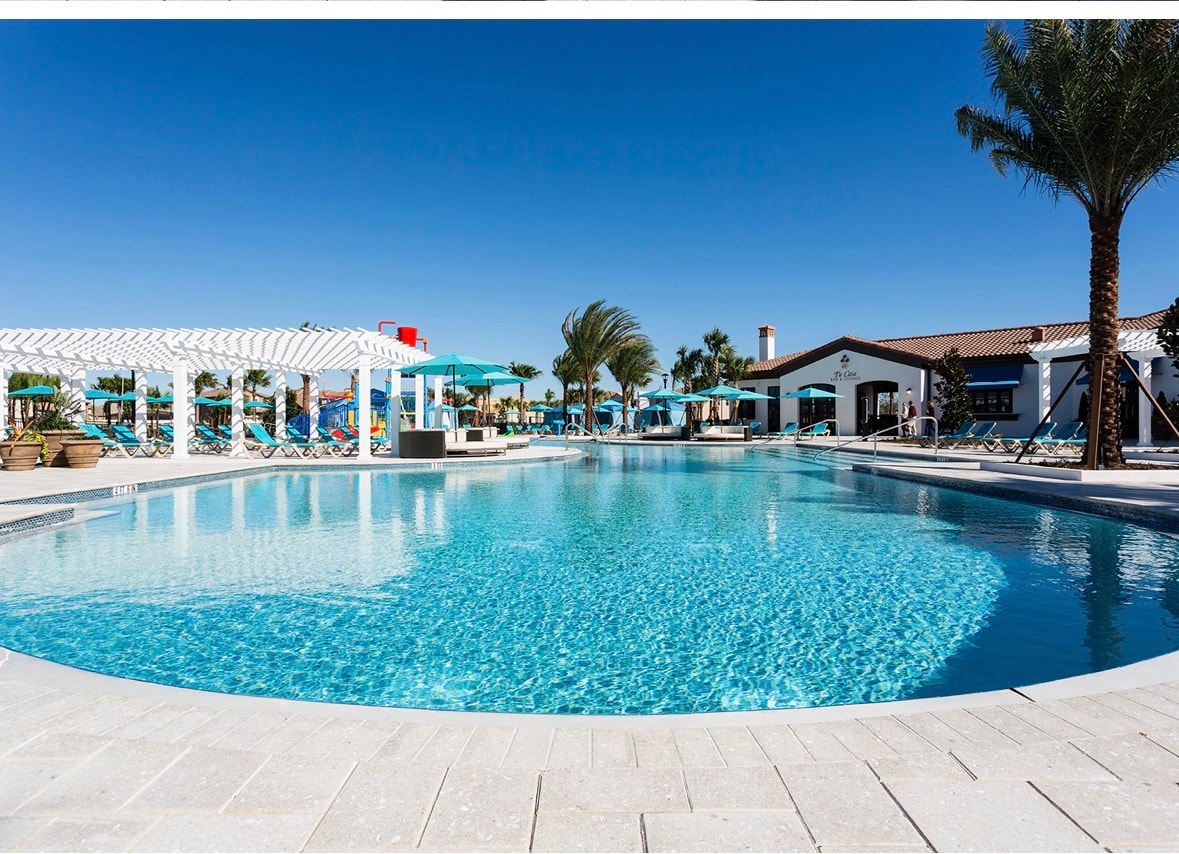 Windsor at Westside resort pool at dusk — lazy river, heated pool, and resort amenities